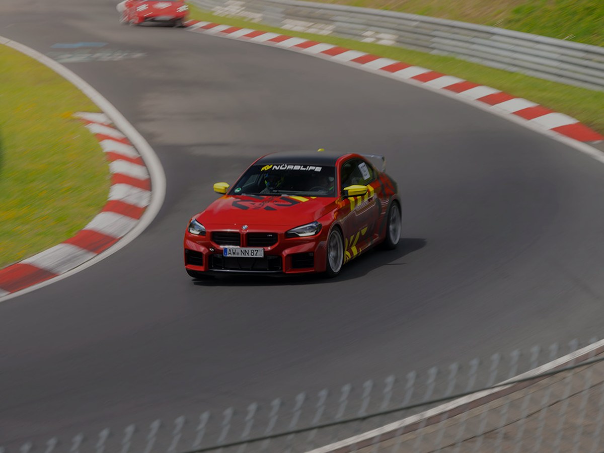 Rental car driving the Nürburgring Nordschleife through the Eifel forest